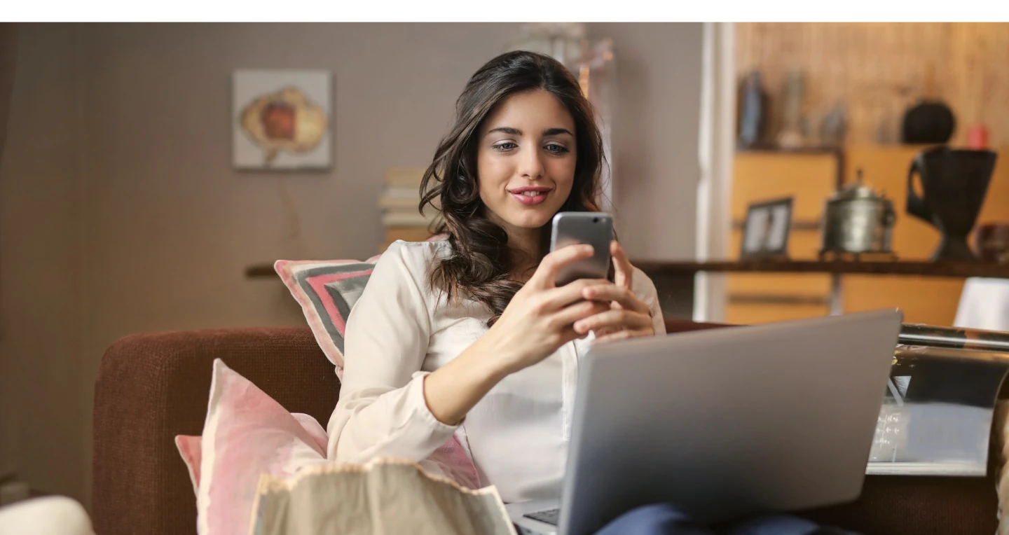 Mulher olhando o celular na mão